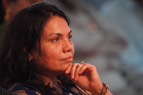 Free Close-up portrait of a woman deep in thought during an event. Stock Photo
