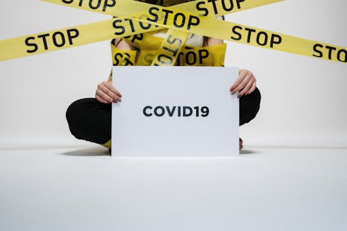 Free Person Holding Covid Sign Stock Photo