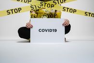 Person Holding Covid Sign