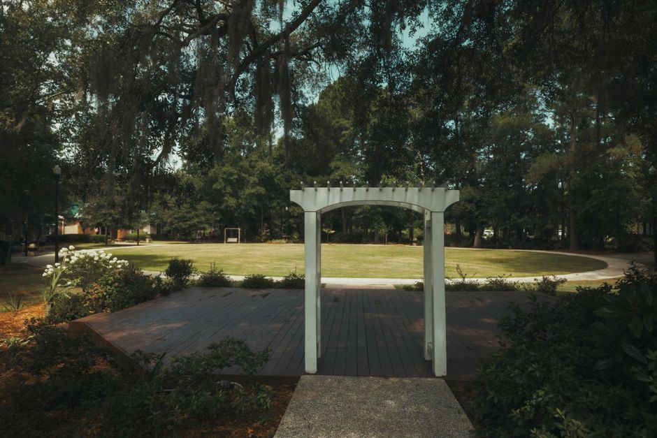Serene garden gazebo surrounded by lush greenery and Spanish moss in Charleston, South Carolina.