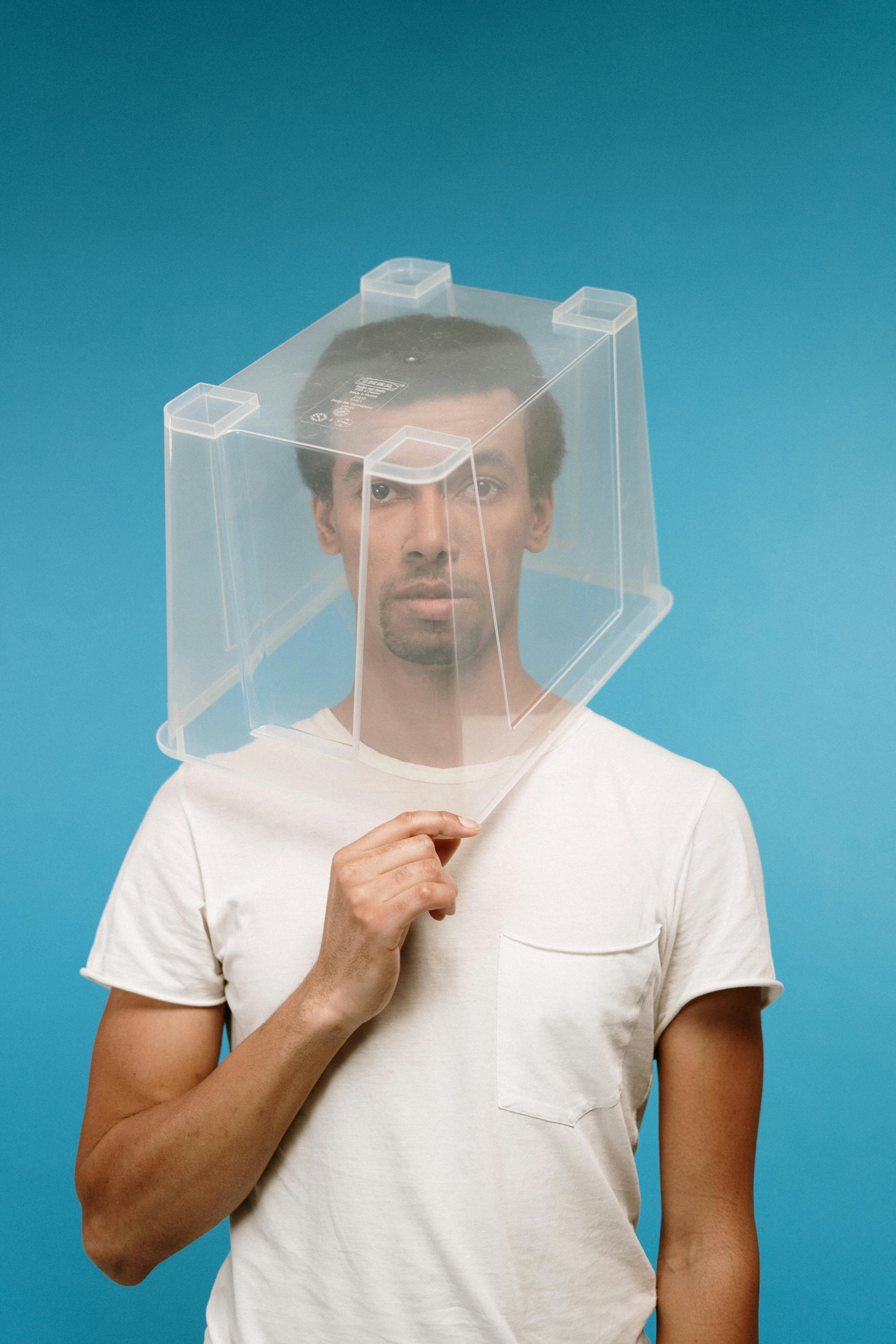 man wearing plastic box on head