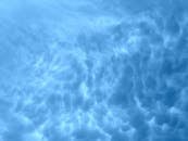 这幅充满活力的蓝色云景描绘了明亮白昼天空中戏剧性的云层形态