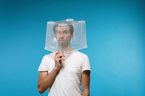 Free Man Wearing Plastic Box on Head Stock Photo