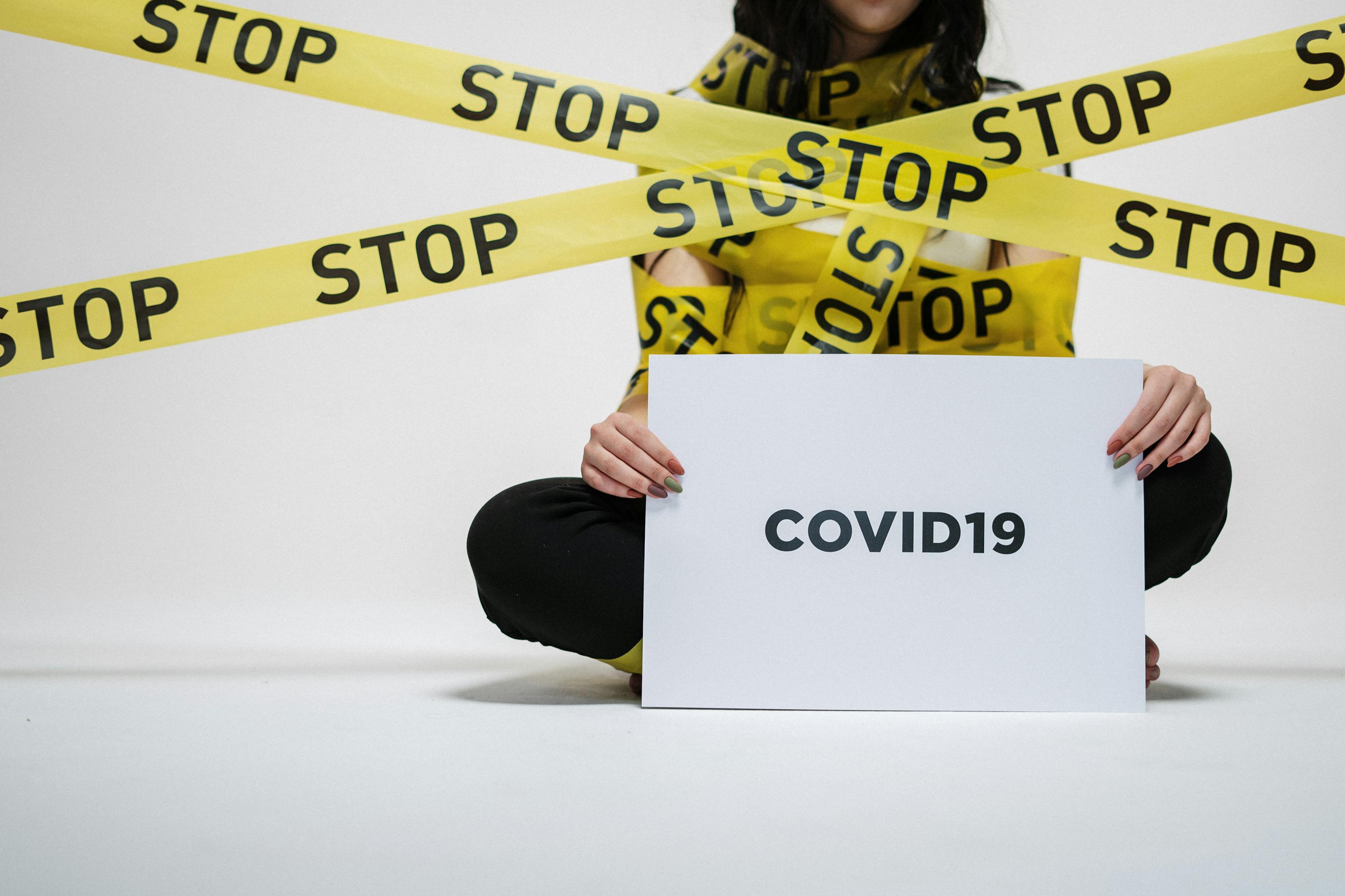 Woman Holding Sign Stop COVID