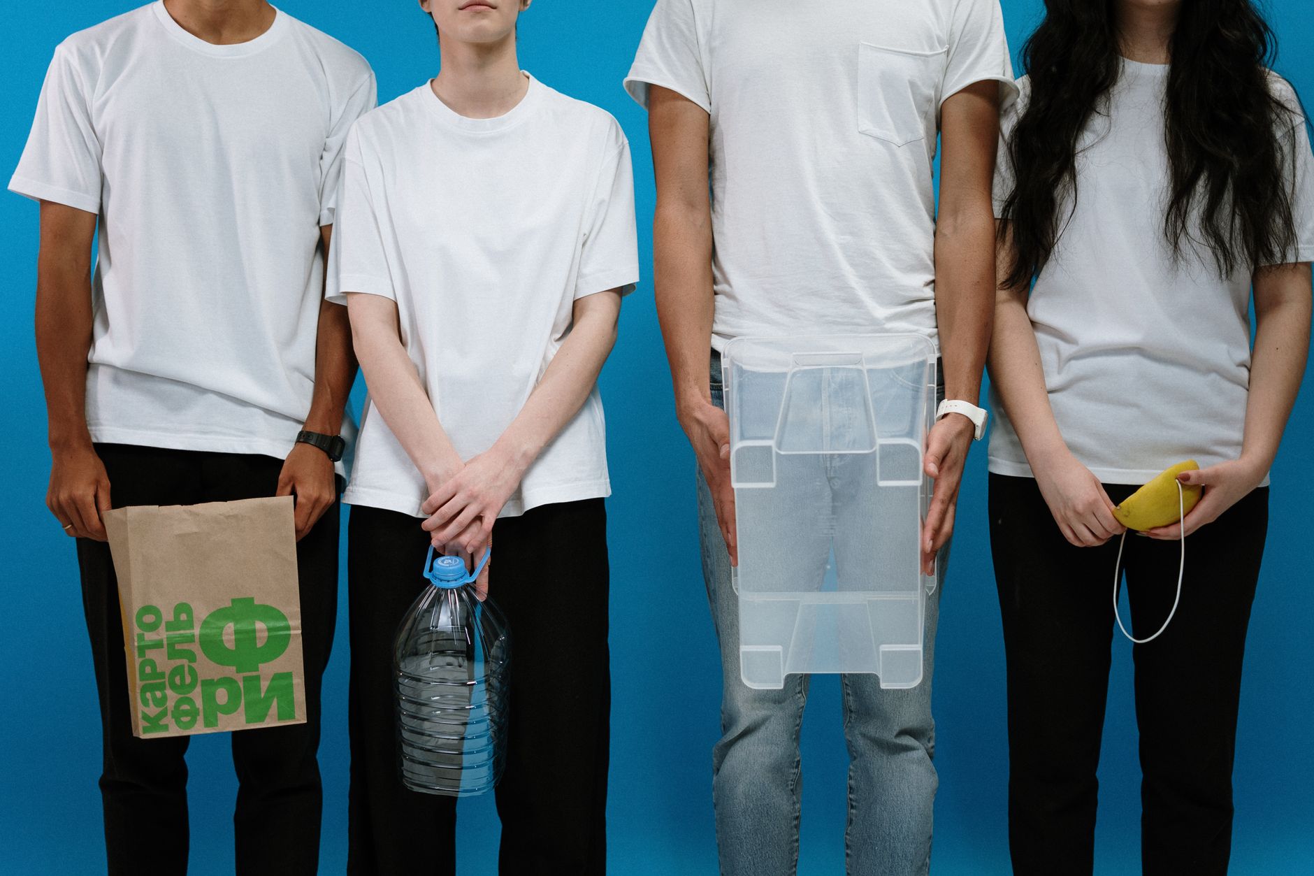 Four adults wearing makeshift protective gear against a blue backdrop.