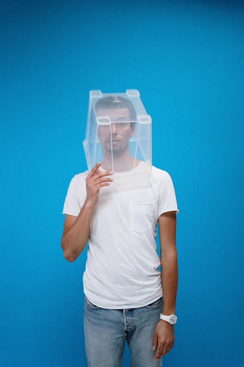 Free Man Wearing Plastic Box on Head Stock Photo