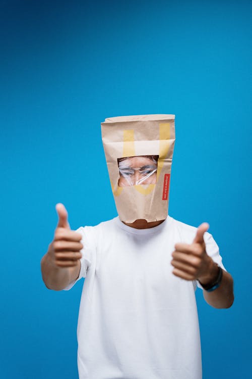 Free Person Wearing A Paper bag On Head As An Alternative To Mask Stock Photo