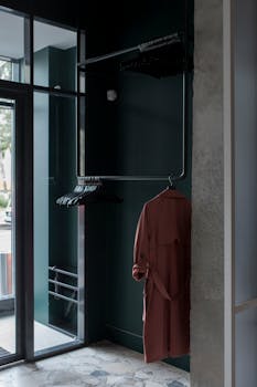 Minimalist interior with a hanging coat in a stylish entryway.