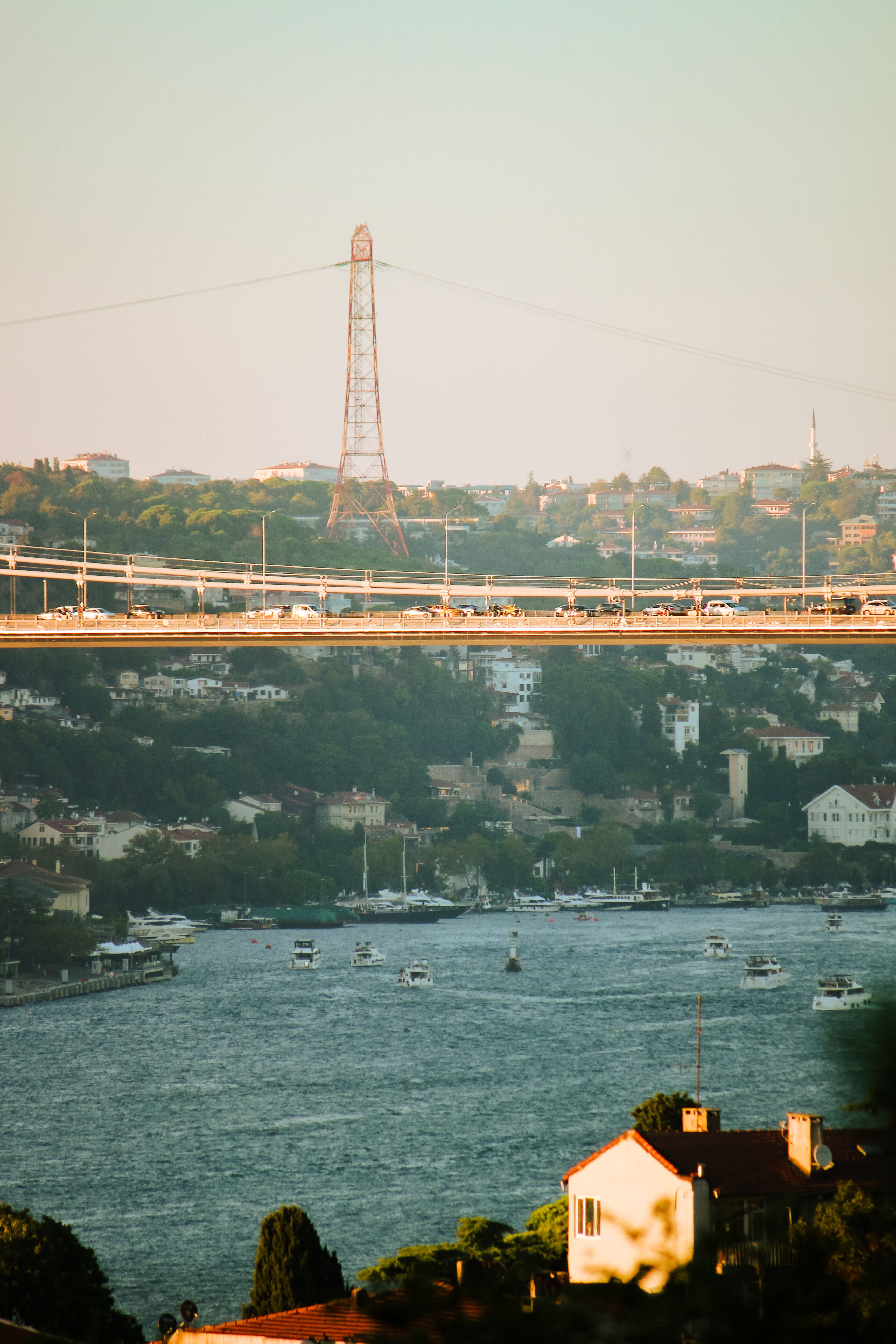 A picturesque view of the Bosphorus Bridge spanning over the bustling Istanbul cityscape.