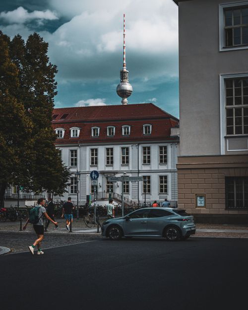 Free Street view in Berlin showcasing the TV Tower and urban life, perfect for travel insights. Stock Photo