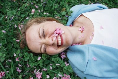 A woman smiling among clover in green grass