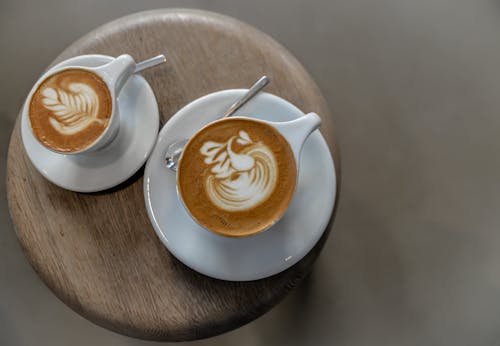Free Two White Ceramic Teacups With Latte Stock Photo
