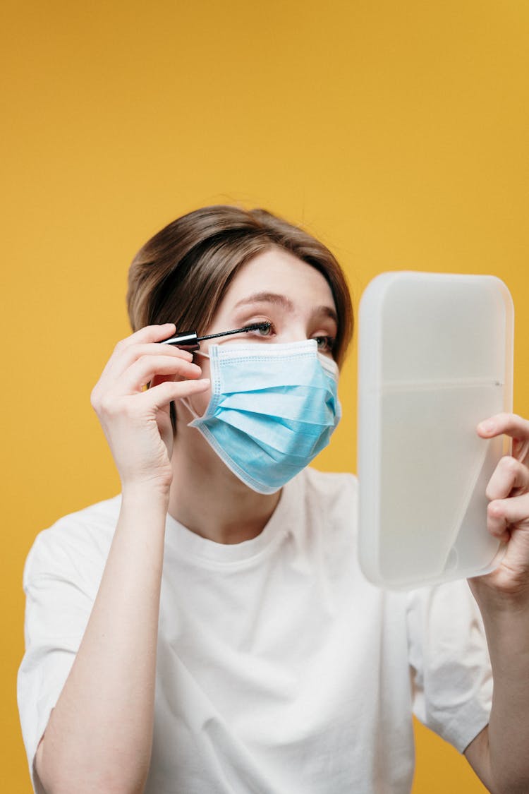 Woman In White Crew Neck T-shirt Covering Her Face With Face Mask