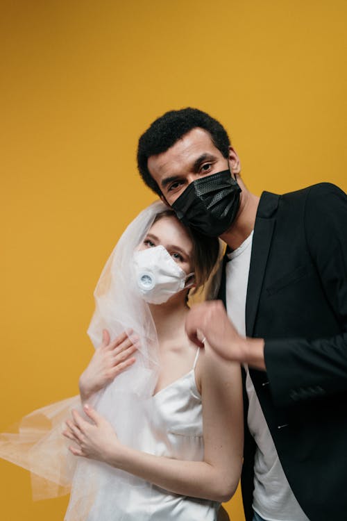 Man in Black Suit Jacket and Woman in White Dress