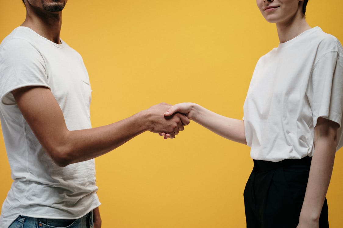 Free People Making Handshake As A Sign Of Success Stock Photo