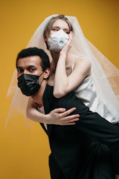 A couple in wedding attire with masks, symbolizing love during a pandemic.