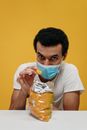Man in White Crew Neck T-shirt Holding a Snack
