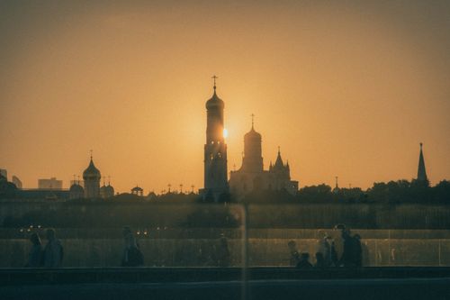 Free Capture of Moscow's iconic skyline at sunset with silhouetted landmarks and people in the foreground. Stock Photo