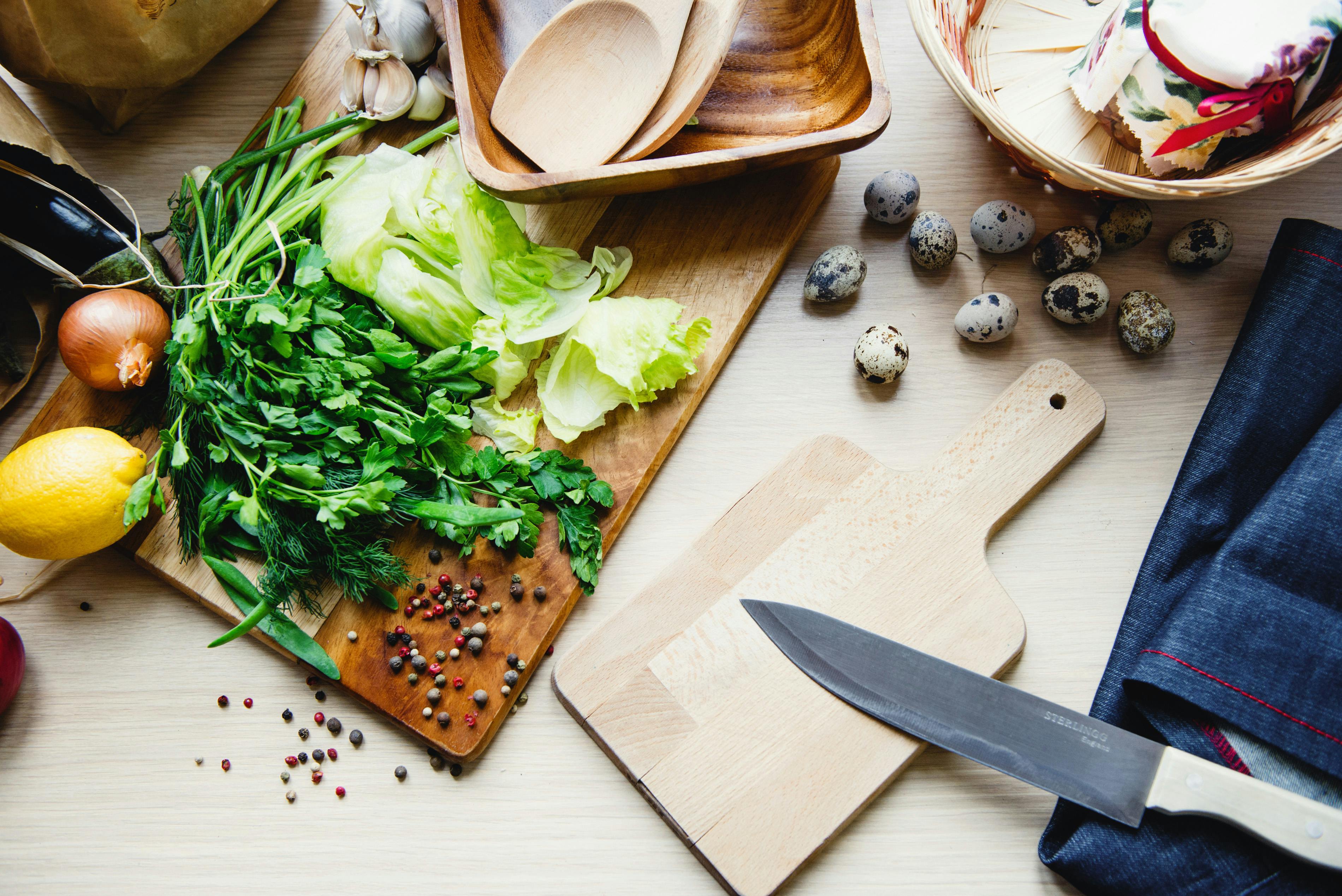 Person cooking at home with winter vegetables on a rustic table