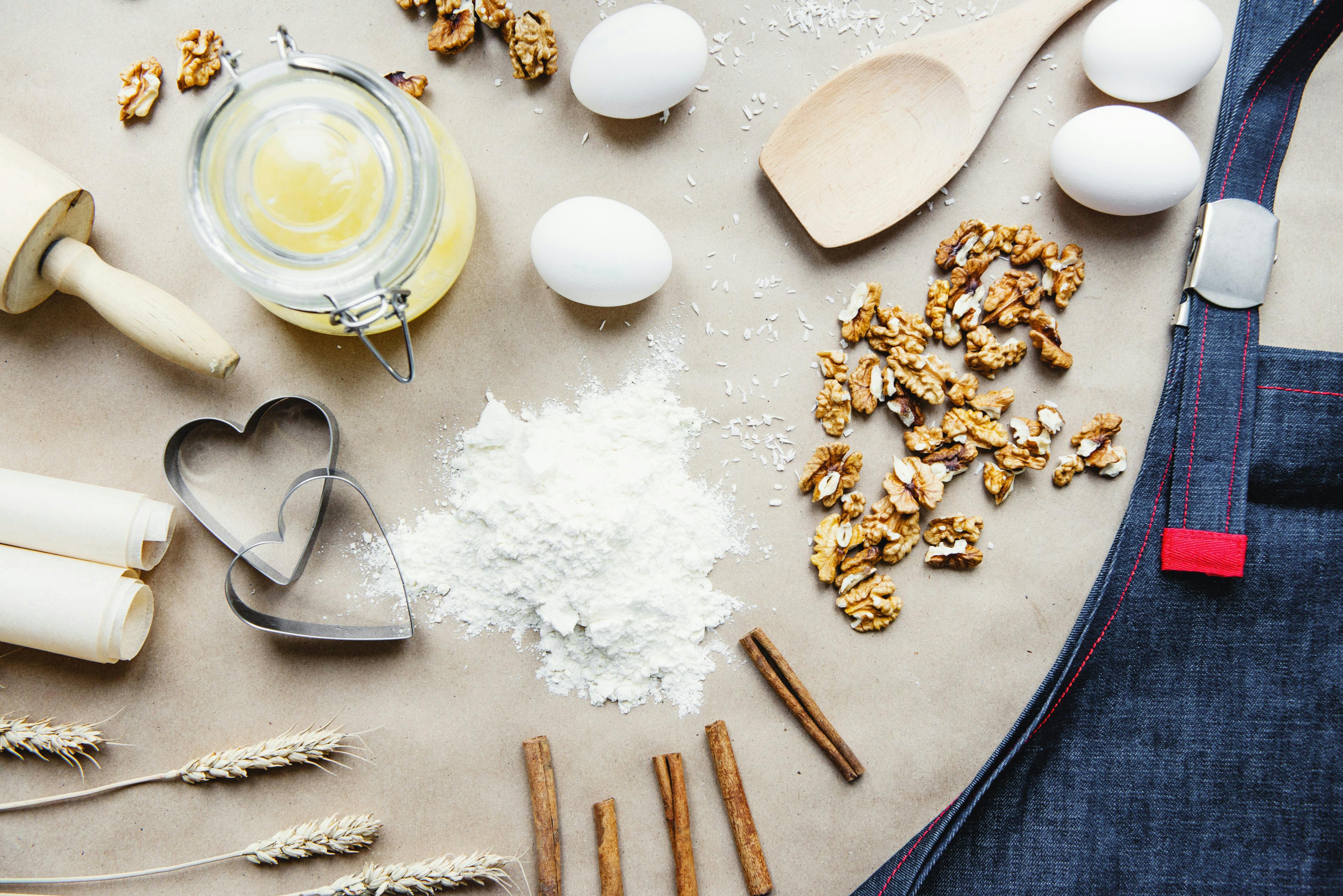 composition-of-baking-ingredients-with-apron-in-kitchen-free-stock-photo