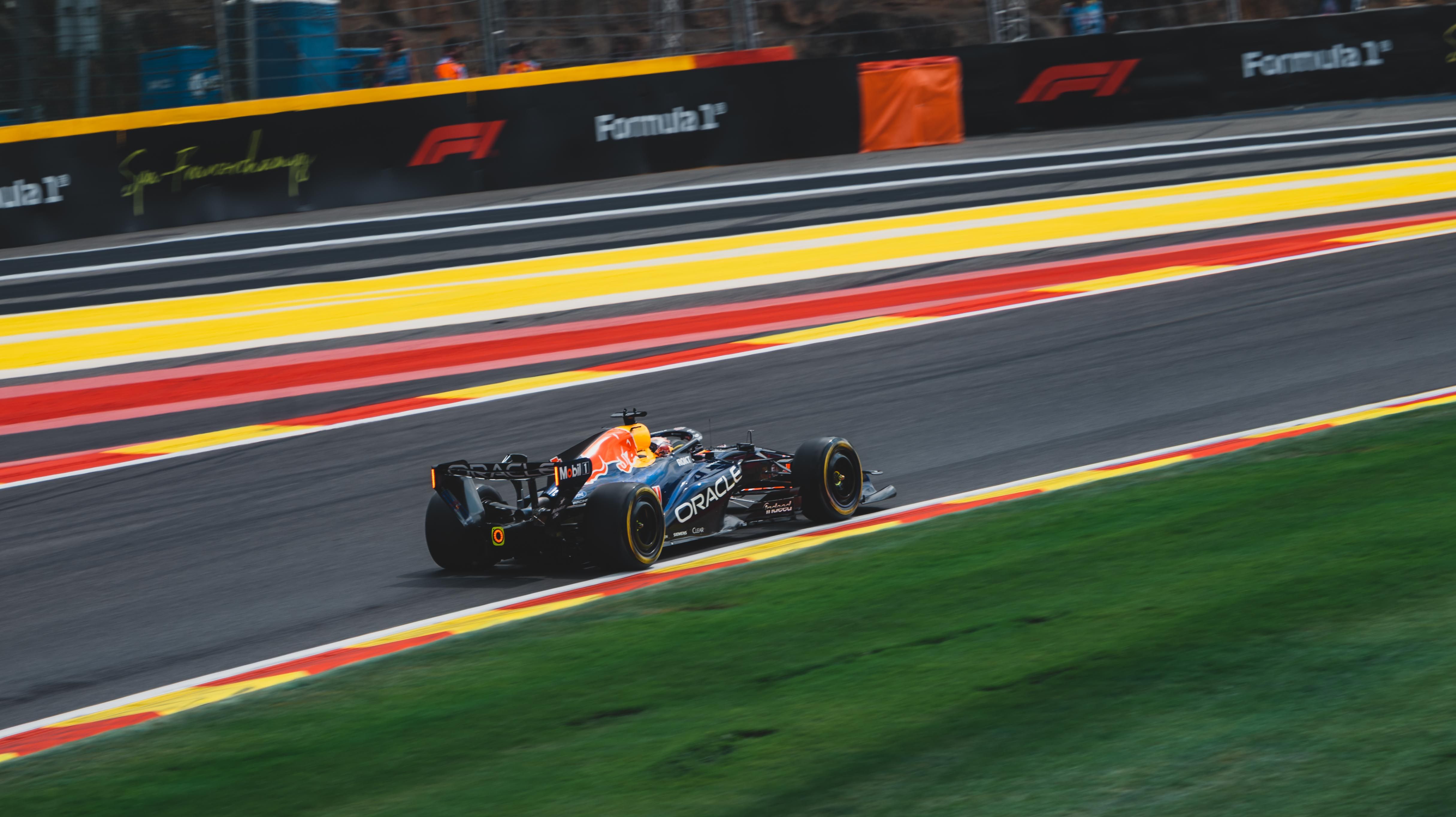 High-speed Formula 1 car on the Circuit de Spa-Francorchamps in Stavelot, Belgium during a sunny race day.