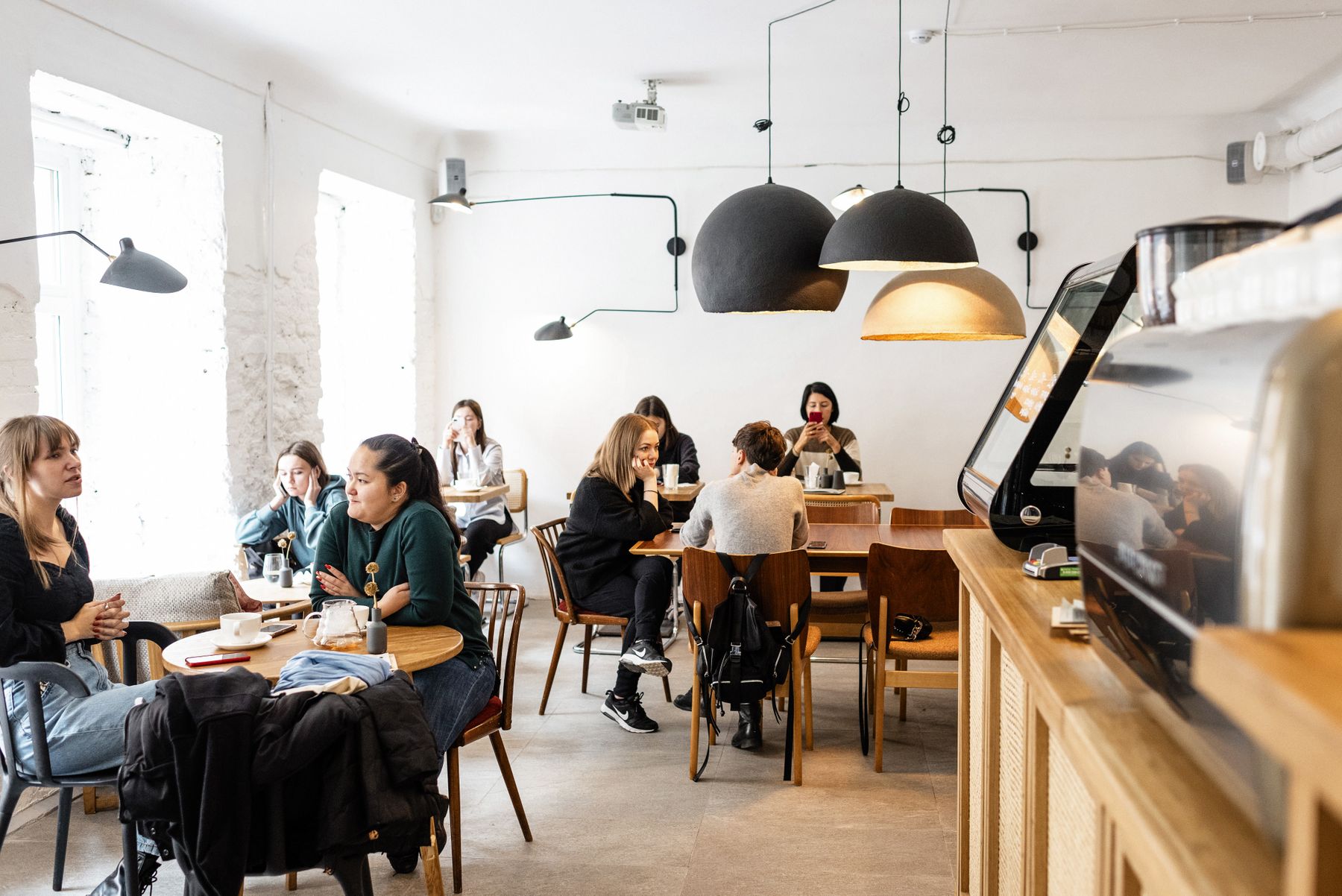 A diverse group of friends talking together in a welcoming café