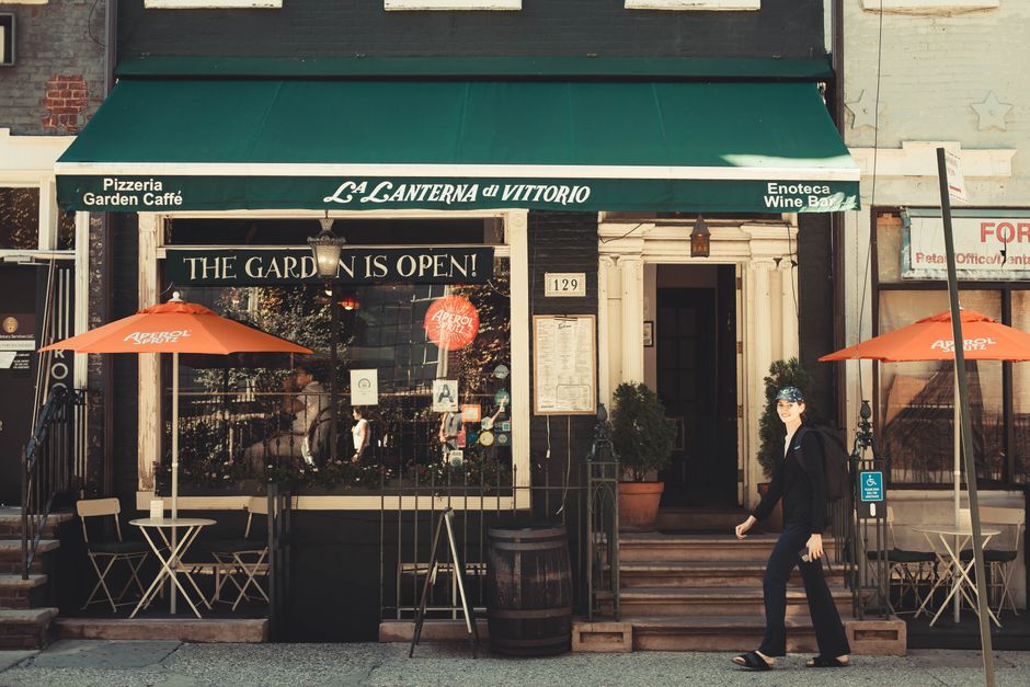 Outside La Lanterna di Vittorio cafe with vibrant umbrellas in New York.