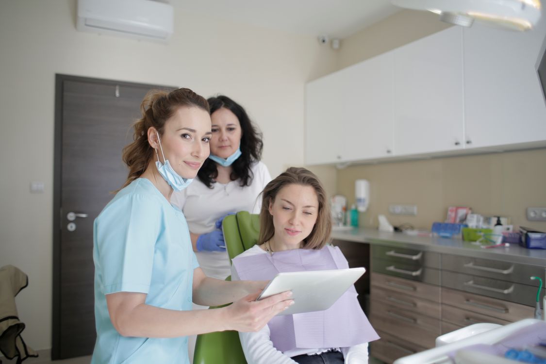 dental team smiling in professional dental office environment
