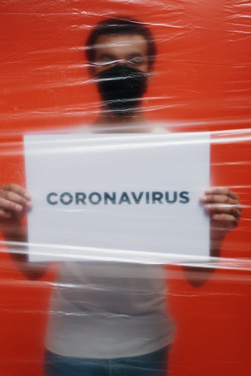 Free Man In Isolation Holding A Placard With Coronavirus Text  Stock Photo