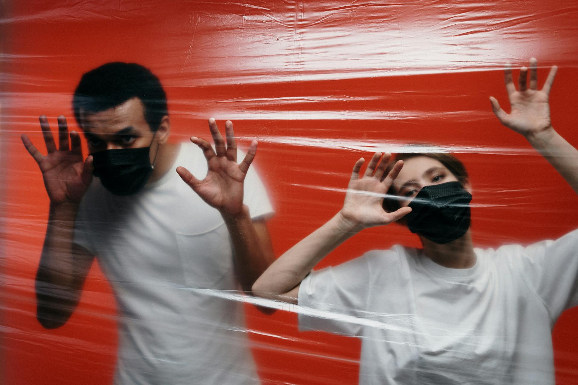 Two People behind Plastic Wrap