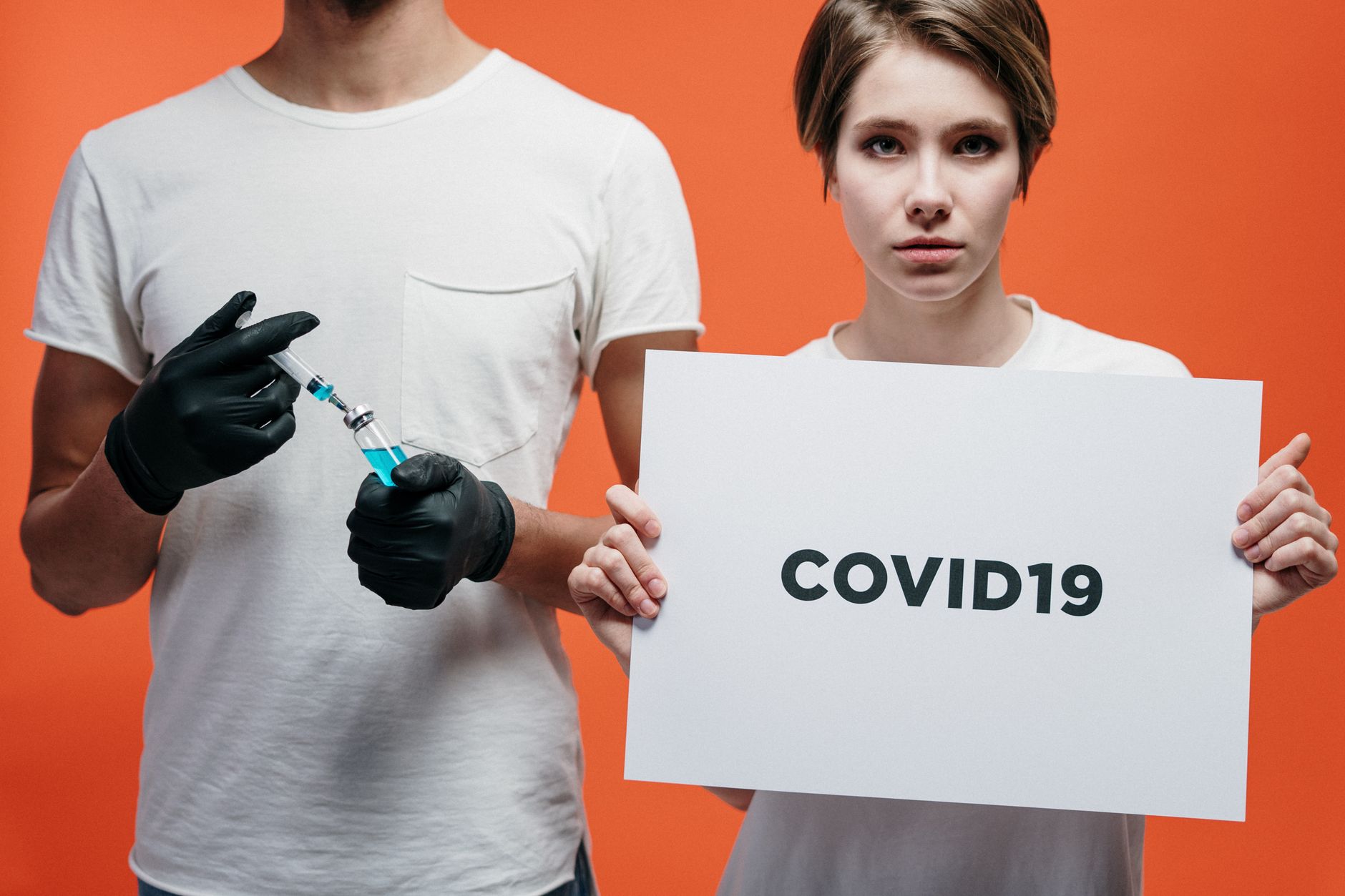 Two individuals highlighting COVID-19 vaccine and awareness on a vibrant backdrop.