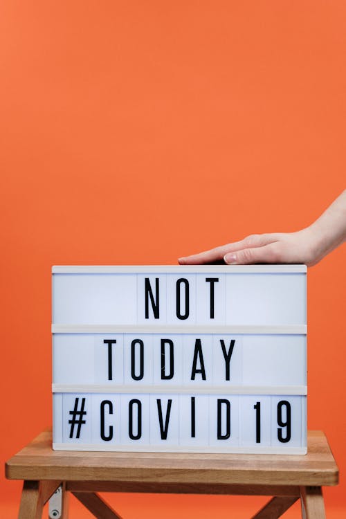 Free Person's Hand On A Covid19 Sign  Stock Photo