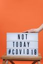 Person's Hand On A Covid19 Sign
