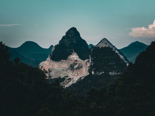 Free Stunning view of rugged mountain peaks with dramatic lighting at sunset. Stock Photo