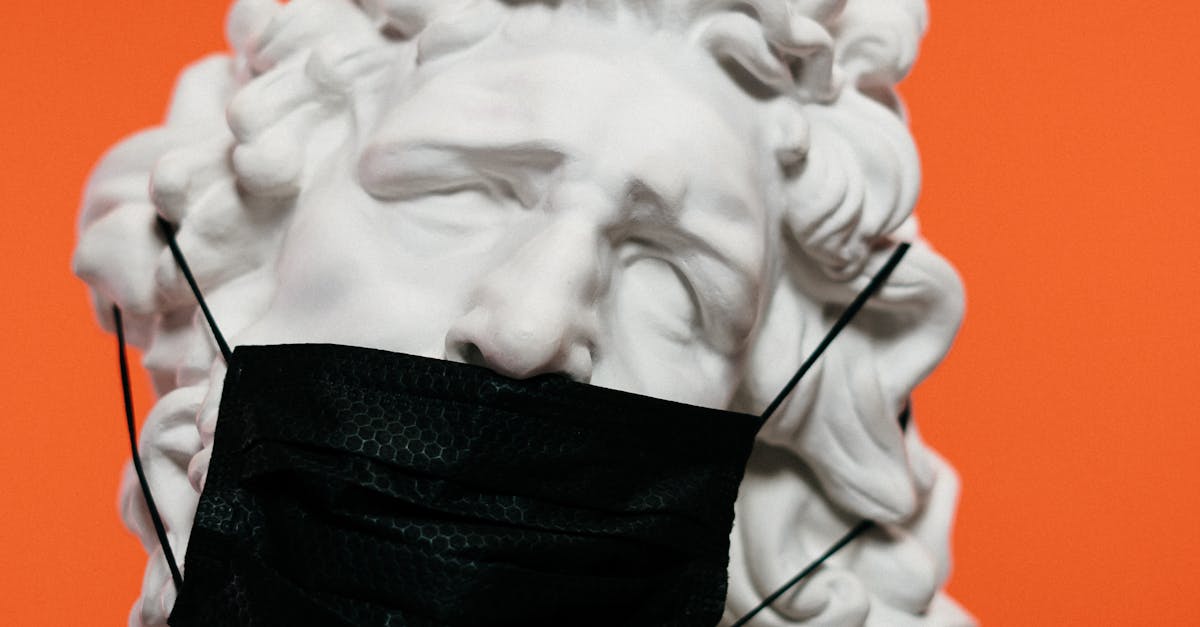White Ceramic Sculpture With Black Face Mask