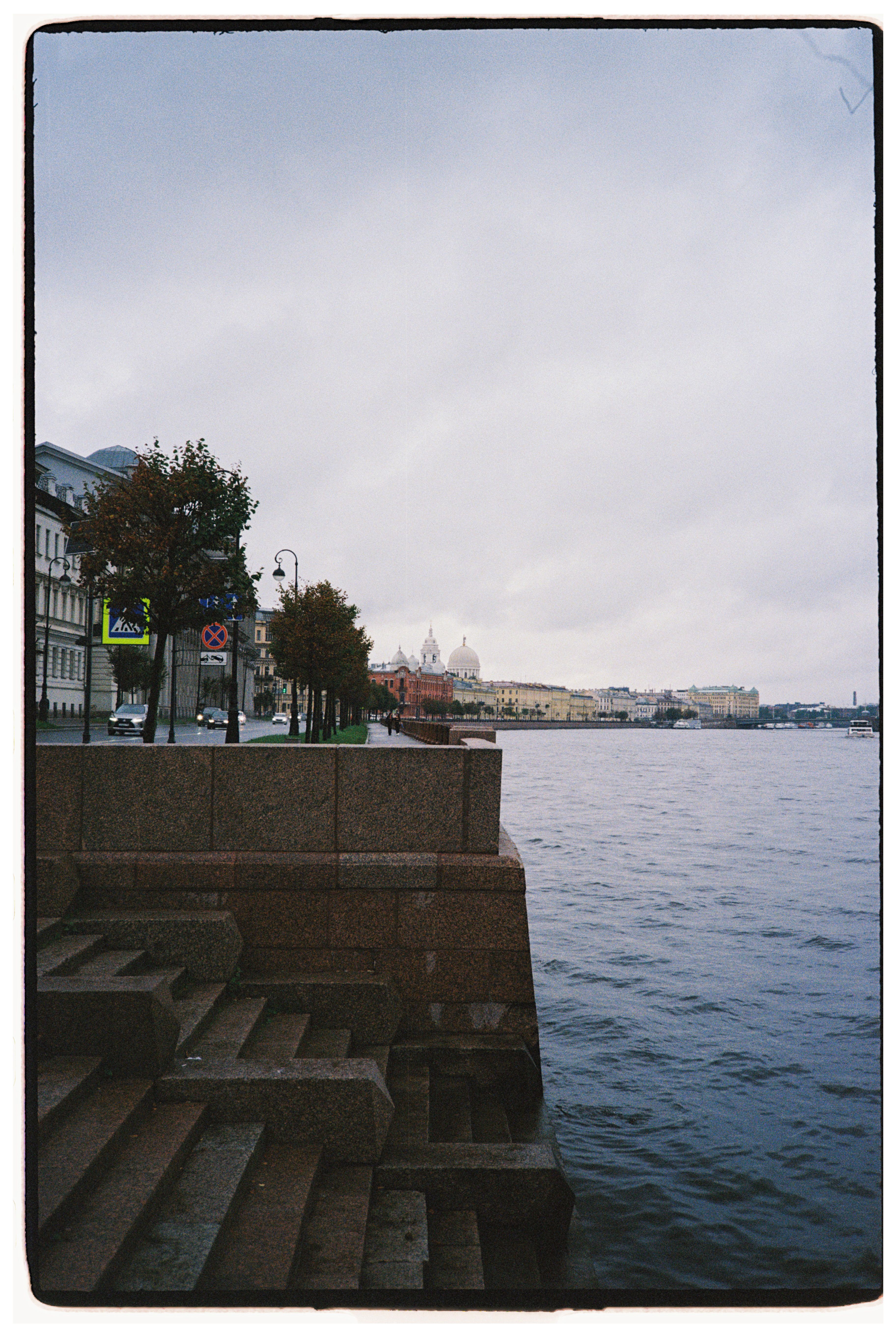A scenic view of the historic riverfront in Saint Petersburg with classic architecture.
