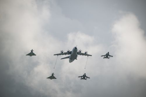 Free A formation of military aircraft flying through a cloudy sky, showcasing aerial coordination. Stock Photo