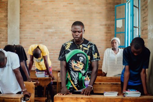 Free A group of African students in a classroom participating in a prayer session. Stock Photo