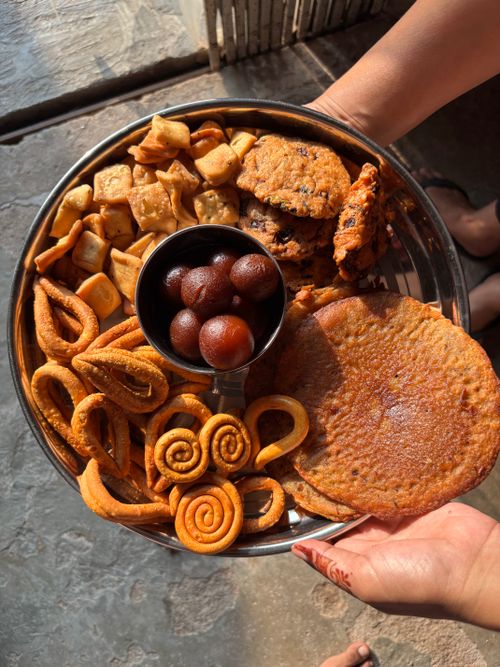 Free A platter showcasing a variety of Indian sweets and snacks under natural light, perfect for festive occasions. Stock Photo