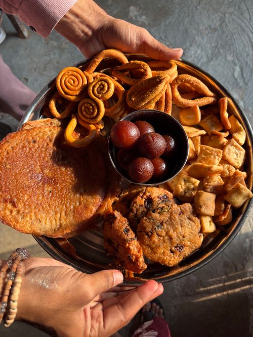 Free A vibrant platter of traditional Indian sweets and snacks in natural light. Stock Photo