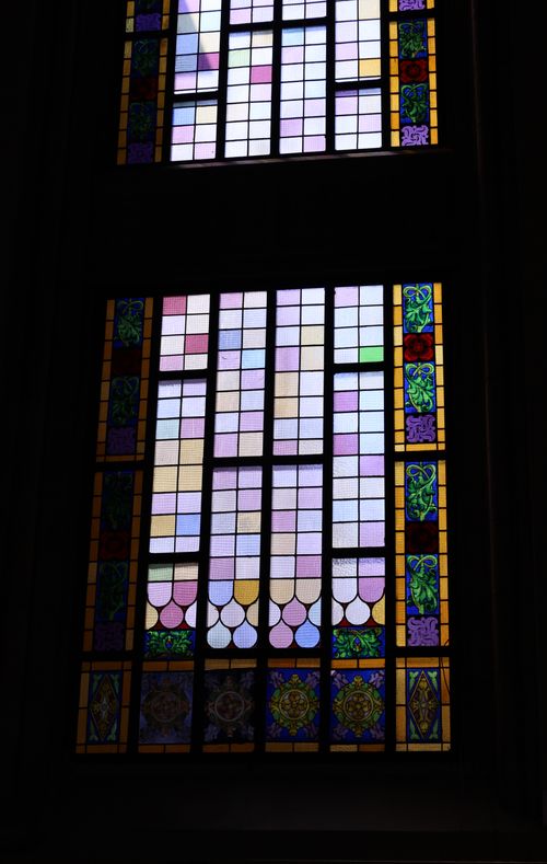 Free Beautiful Gothic stained glass window with colorful patterns and floral designs. Stock Photo