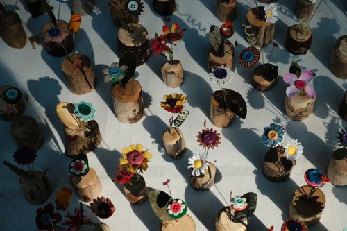 Free Arrange of handmade wooden flower decorations casting artistic shadows, evoking creativity and natural beauty. Stock Photo