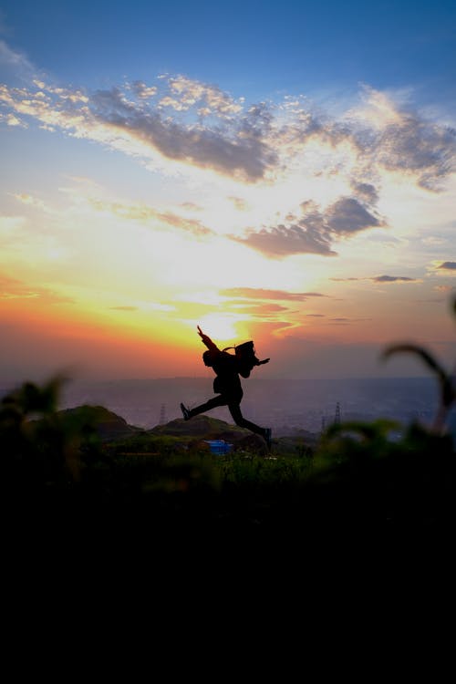 Silhouette Of Man Jumping During Sunset