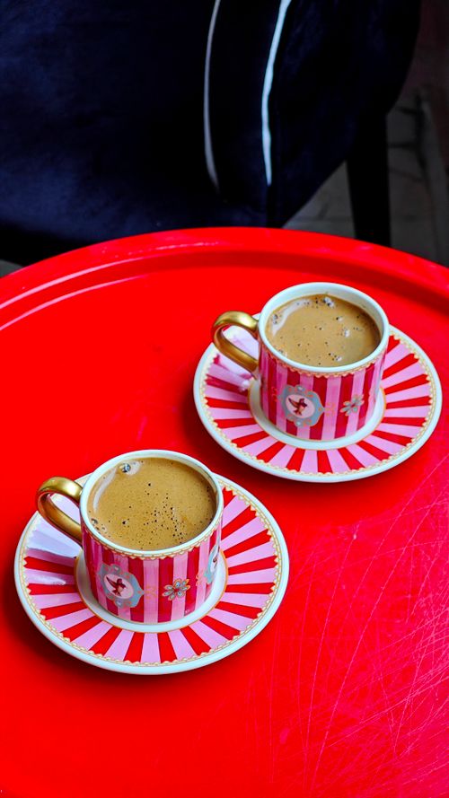 Free A top-down view of two espresso cups on a bright red table, perfect for coffee themes. Stock Photo
