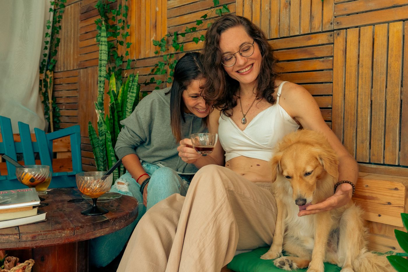 A woman sharing a cozy moment with a dog in a warm everyday setting