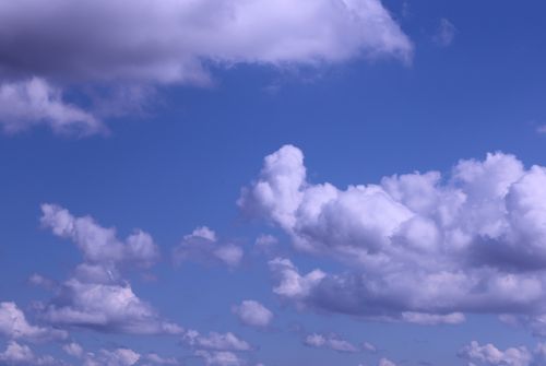 Free Beautiful cumulus clouds against a bright blue sky, showcasing nature's beauty. Stock Photo