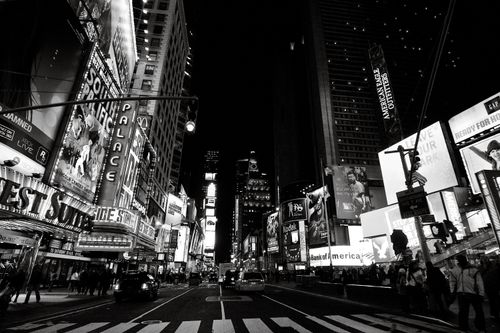 Free Iconic Times Square captured at night in monochrome, showcasing bustling city life in New York City. Stock Photo