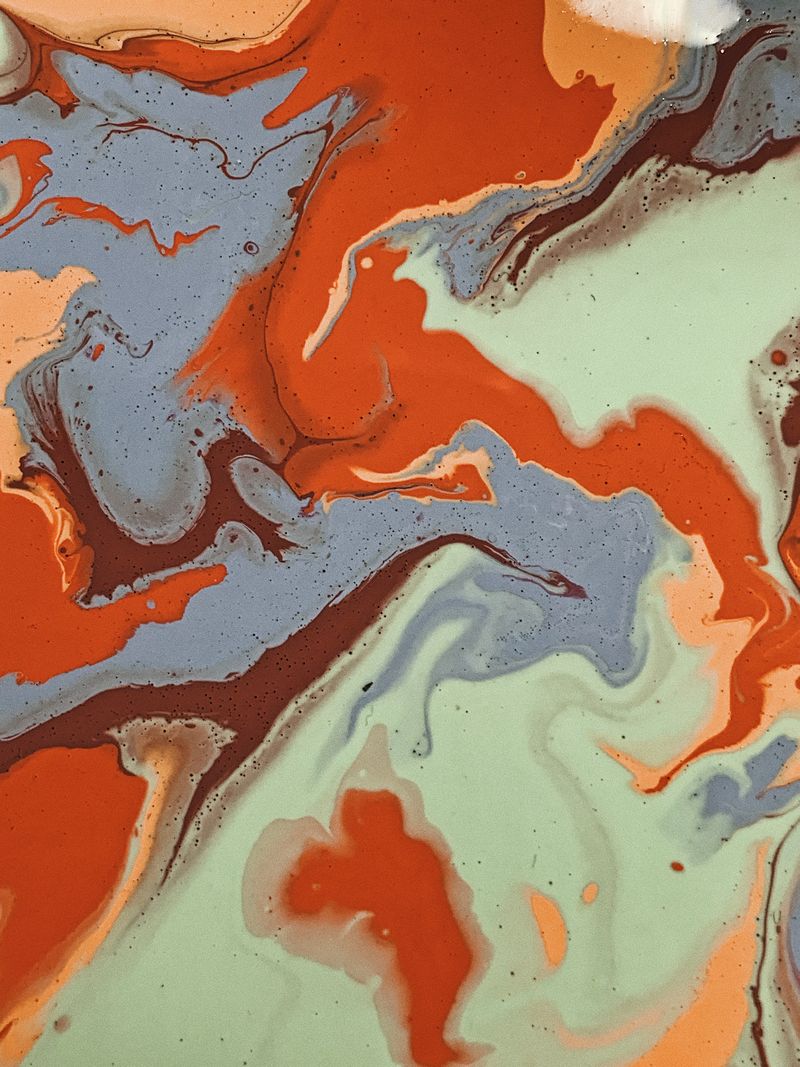 Marbled swirls of orange, blue and green