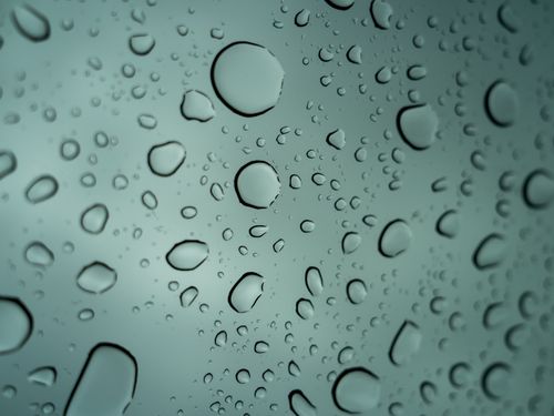 Free Macro photography of raindrops on a glass surface showing texture and transparency. Stock Photo