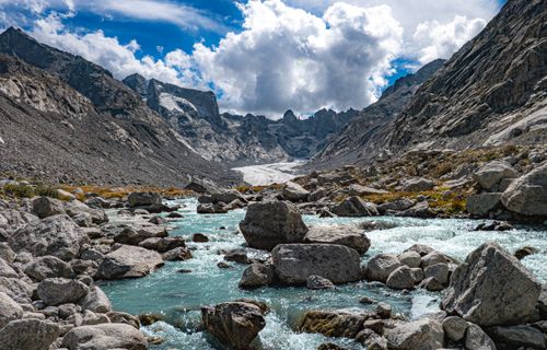 Free Majestic view of a glacier-fed stream flowing through the Bregaglia mountains in Switzerland. Stock Photo
